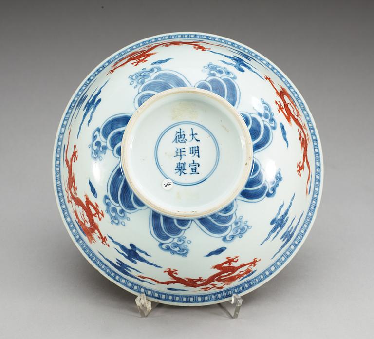 A blue and white bowl with a dragon in copper red, Qing dynasty with Xuande six character mark.