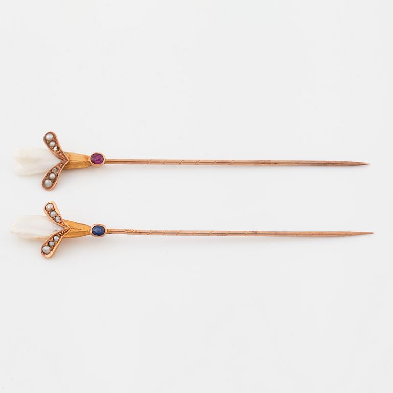 Two pins set with cultured pearls and a synthetic ruby and a synthetic sapphire.