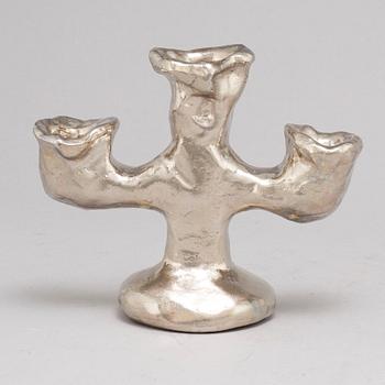 DAN WOLGERS, a silvergilt bronze candle stick, signed.