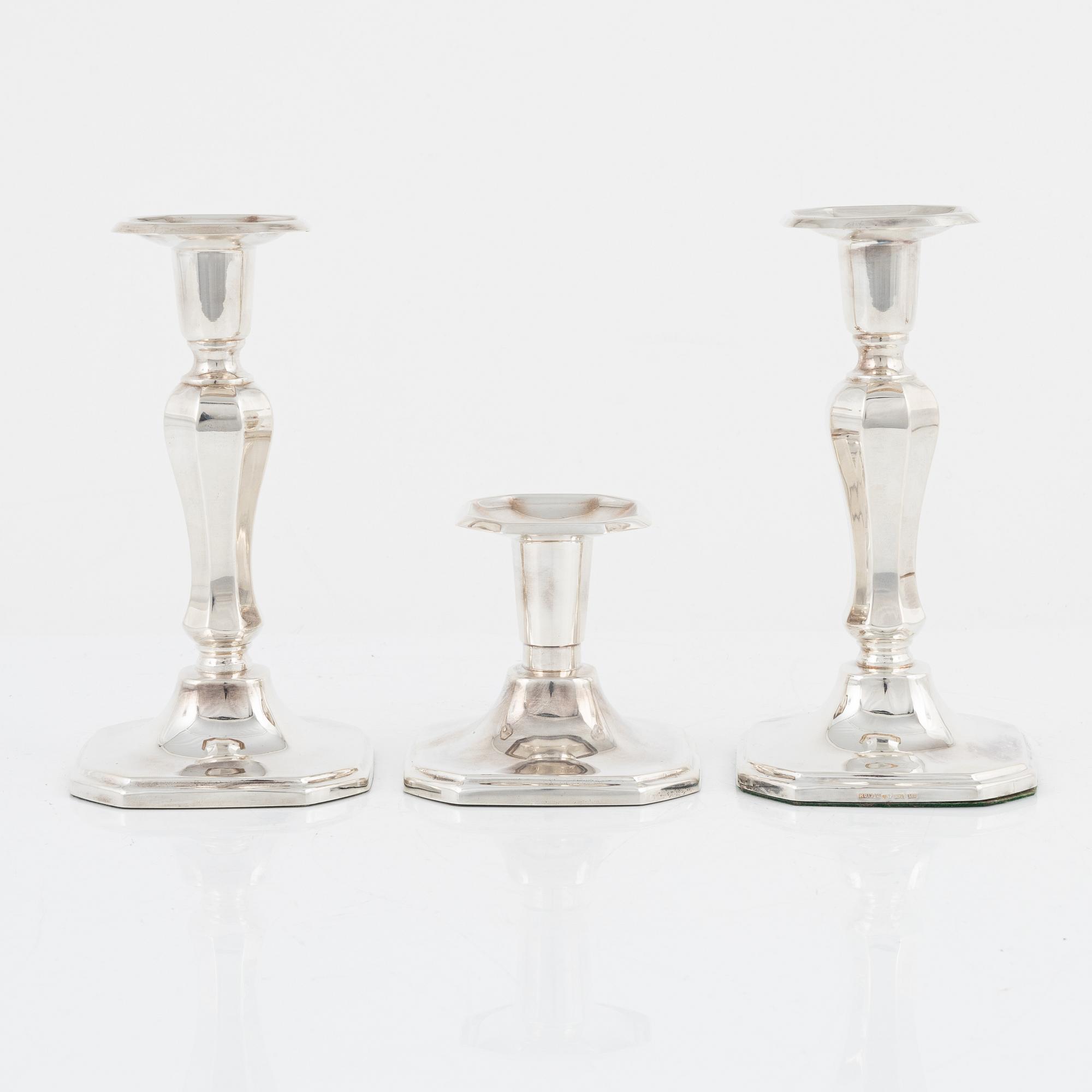 A pair of silver candlesticks, MGAB, Uppsala, 1985 and a silver candlestick, MEMA, Lidköping, 1987.