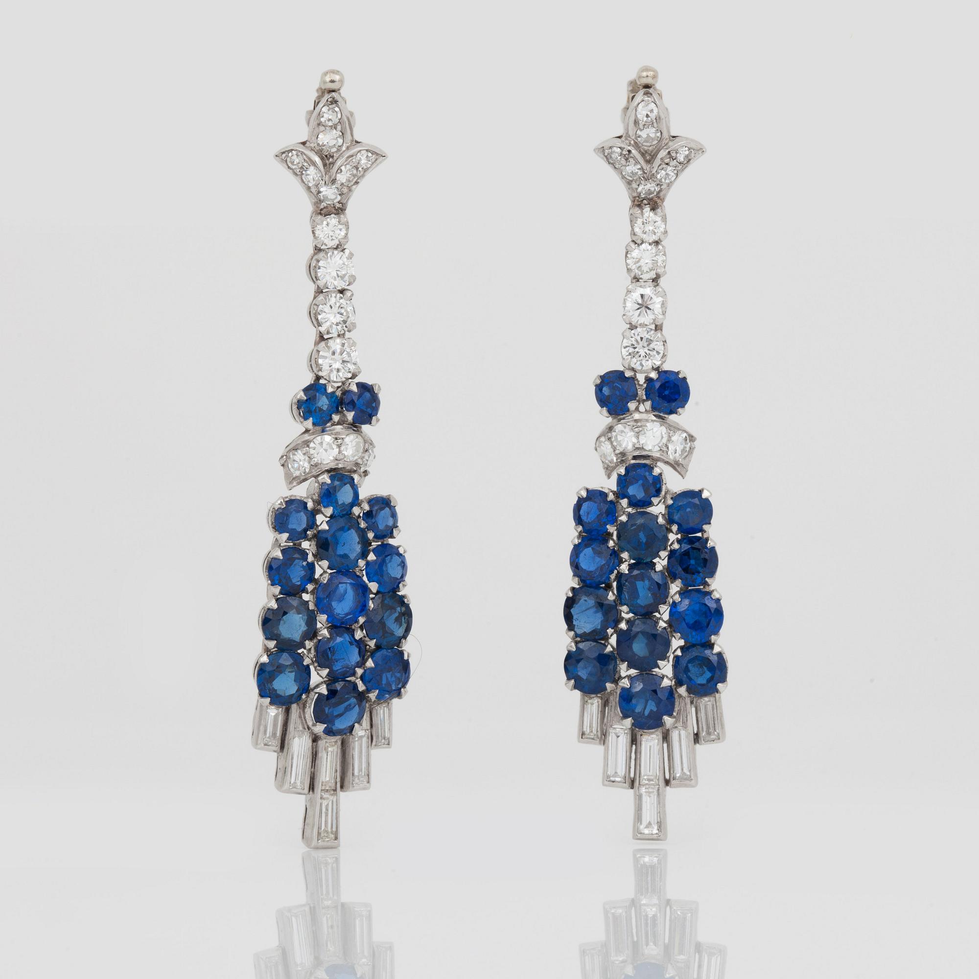 A diamond and sapphire set, probably Garrard & co. The set can be worn as a necklace, earrings, double clip or brooch.