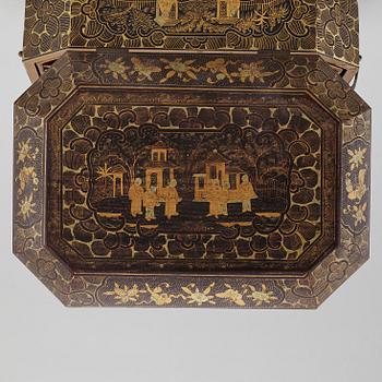 A lacquered sewing cabinet, Qing dynasty, 19th century.