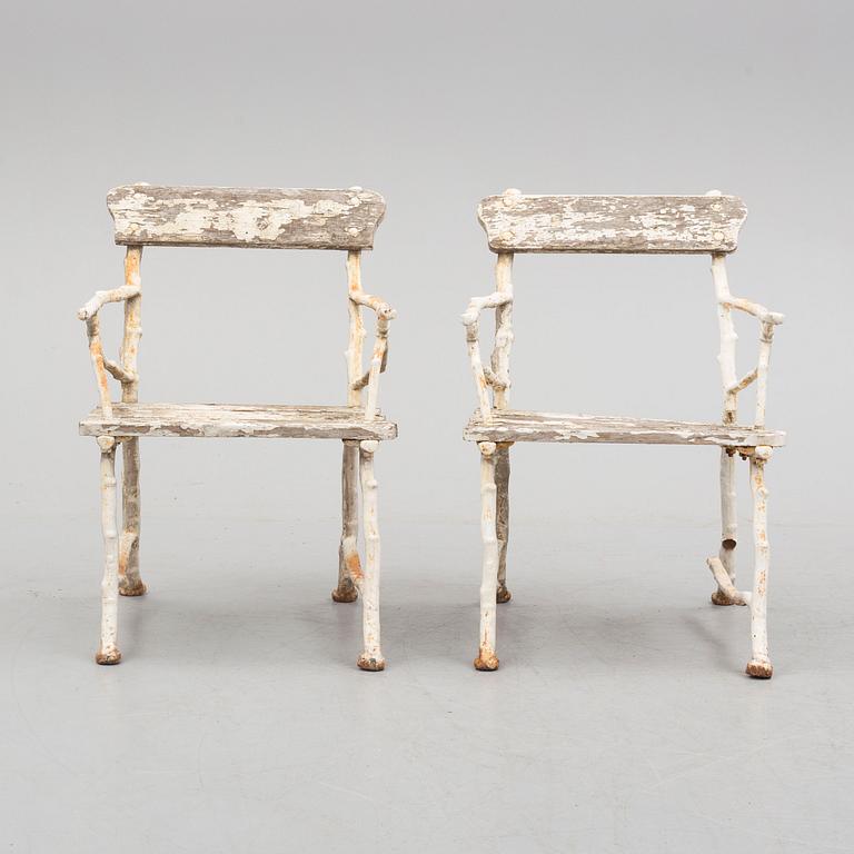 a pair of early 20th century garden cast iron chairs.