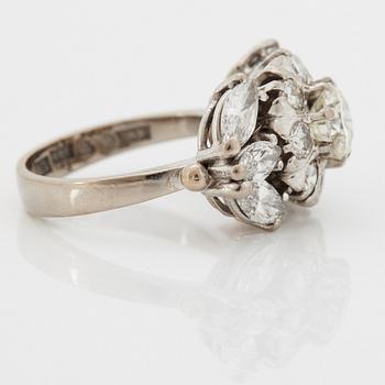 An 18K white gold ring set with round brilliant- and navette-cut diamonds.