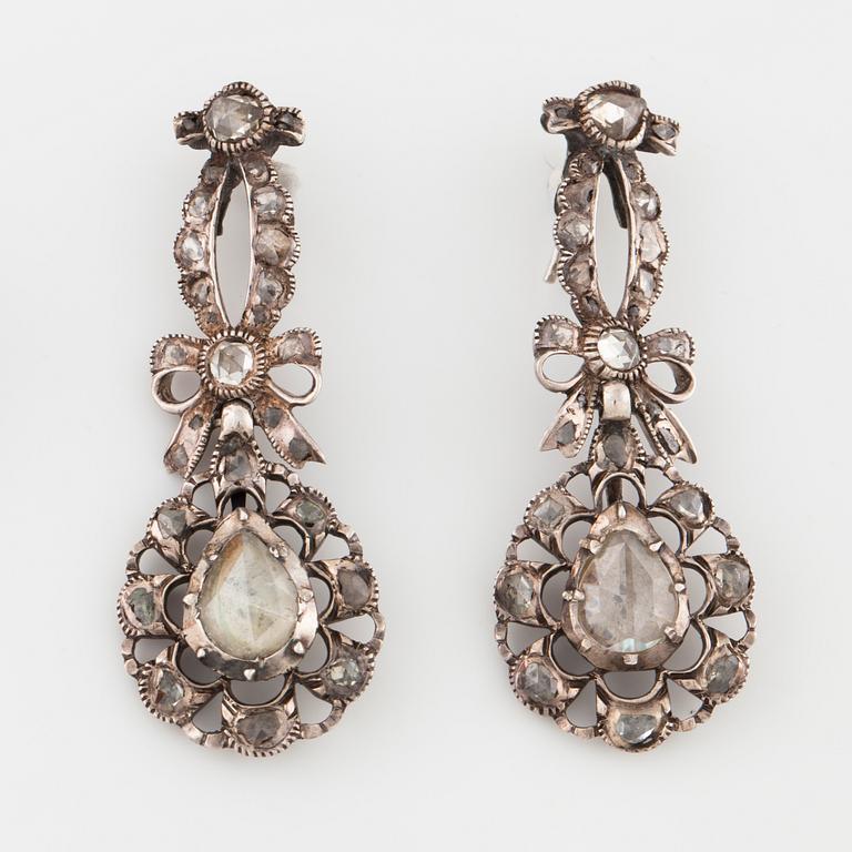 A pair of earrings and a brooch set with rose cut diamonds.