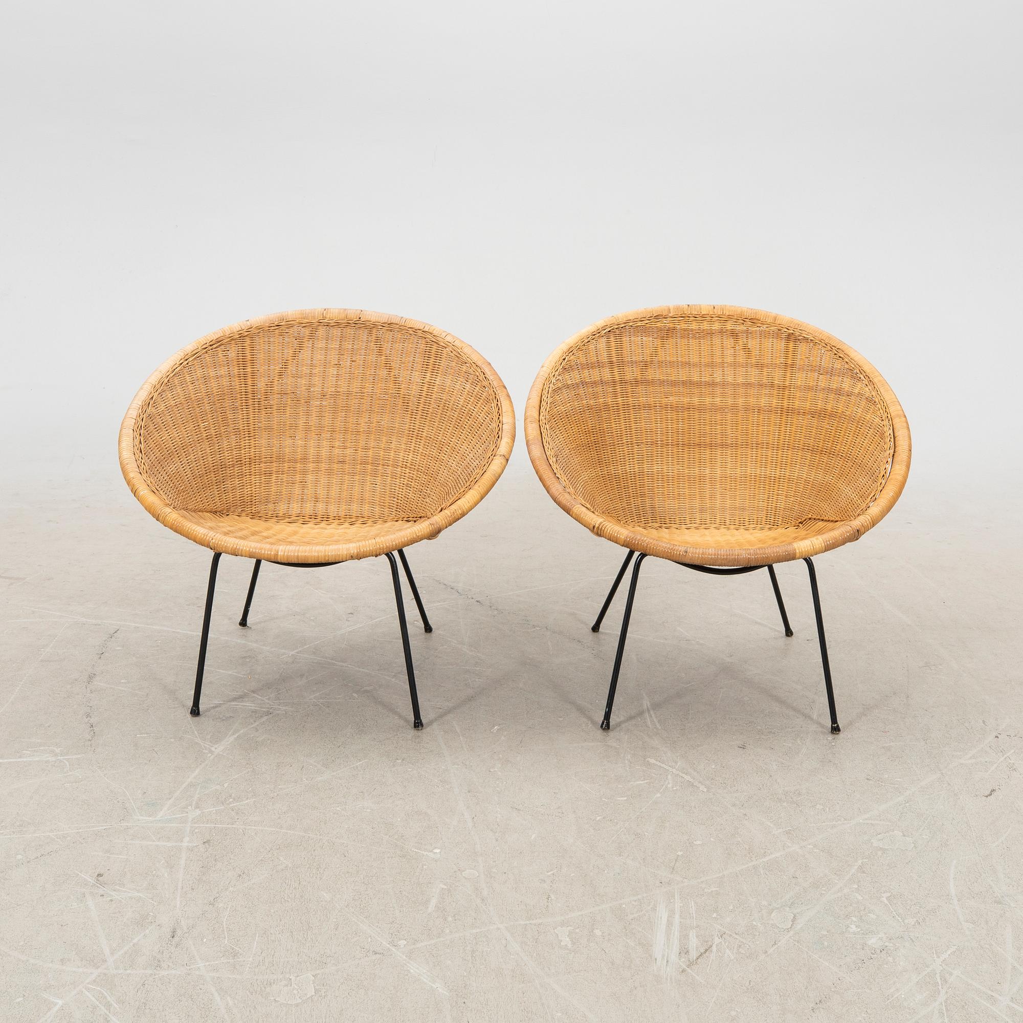 A pair of rattan 1950s easy chairs.