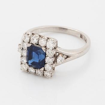 A platinum ring set with a faceted sapphire.