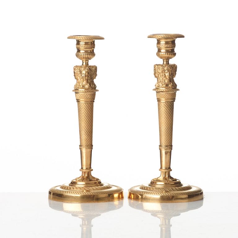 A pair of French Empire early 19th century gilt bronze candlesticks.