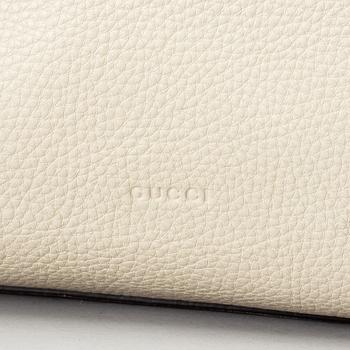 GUCCI, a white leather tote bag with bamboo handles.