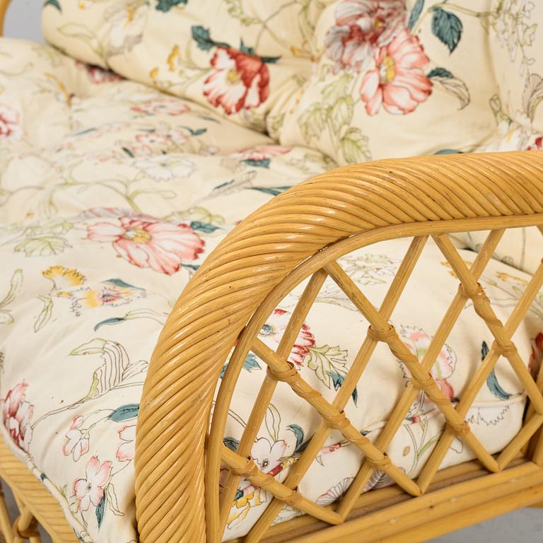 A rattan sofa and two armchairs, later part of the 20th century.