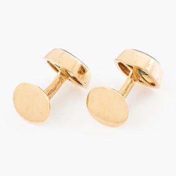 Ett par manschettknappar 18K guld med gröna stenar.