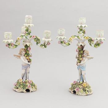 A pair of porcelain rococo style candelabra and a centerpiece bowl, Plaue, Germany, first half of the 20th century.