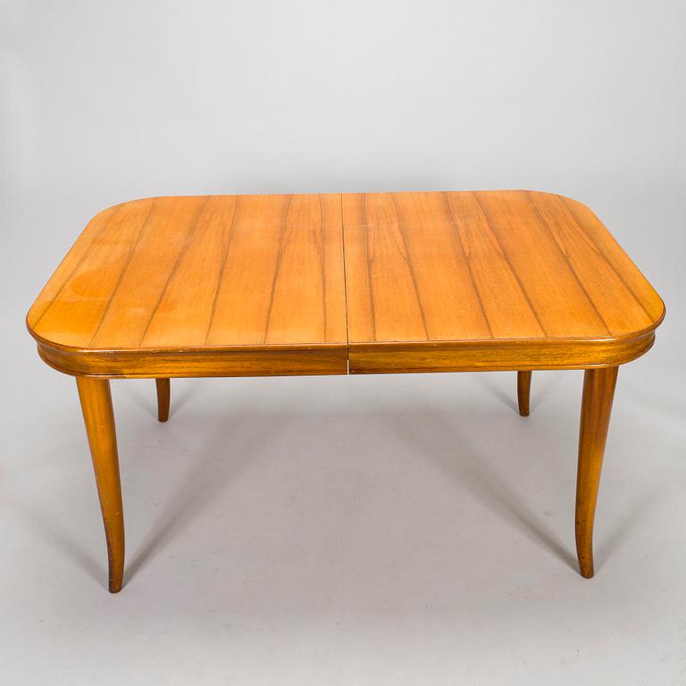 A mid 20th century dining table and a set of four chairs, Oy Boman Ab and two chairs Werner West.