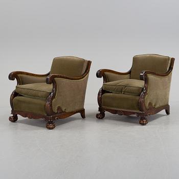 A pair of armchairs and a table, mid 20th century.