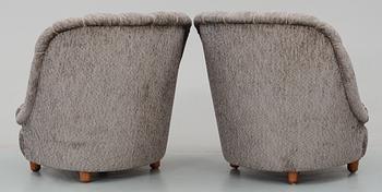 A pair of Carl Malmsten 'Redet' (The Nest) easy chairs with ottomans,