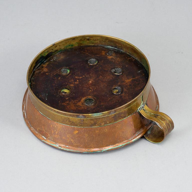 A 19th century copper and brass night light holder.