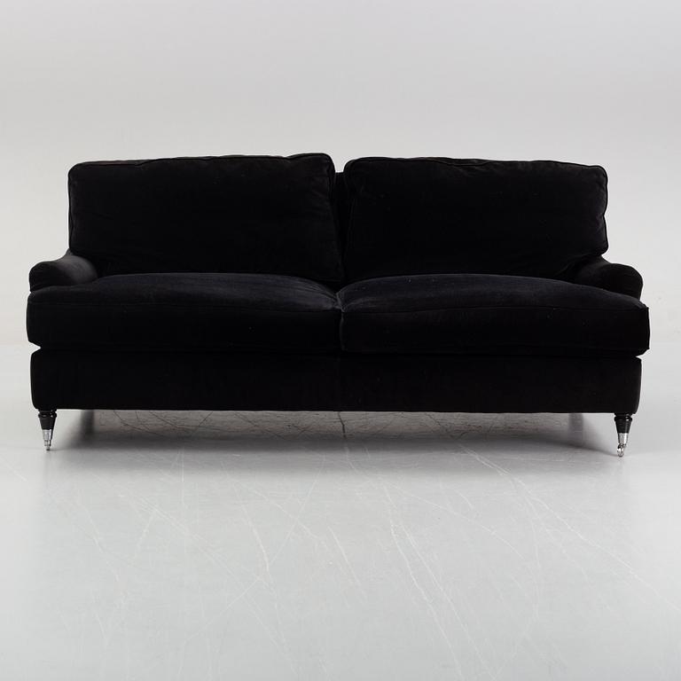 A contemporary velvet Howard sofa.