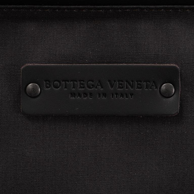 Bottega Veneta, an intrecciato leather suitcase.