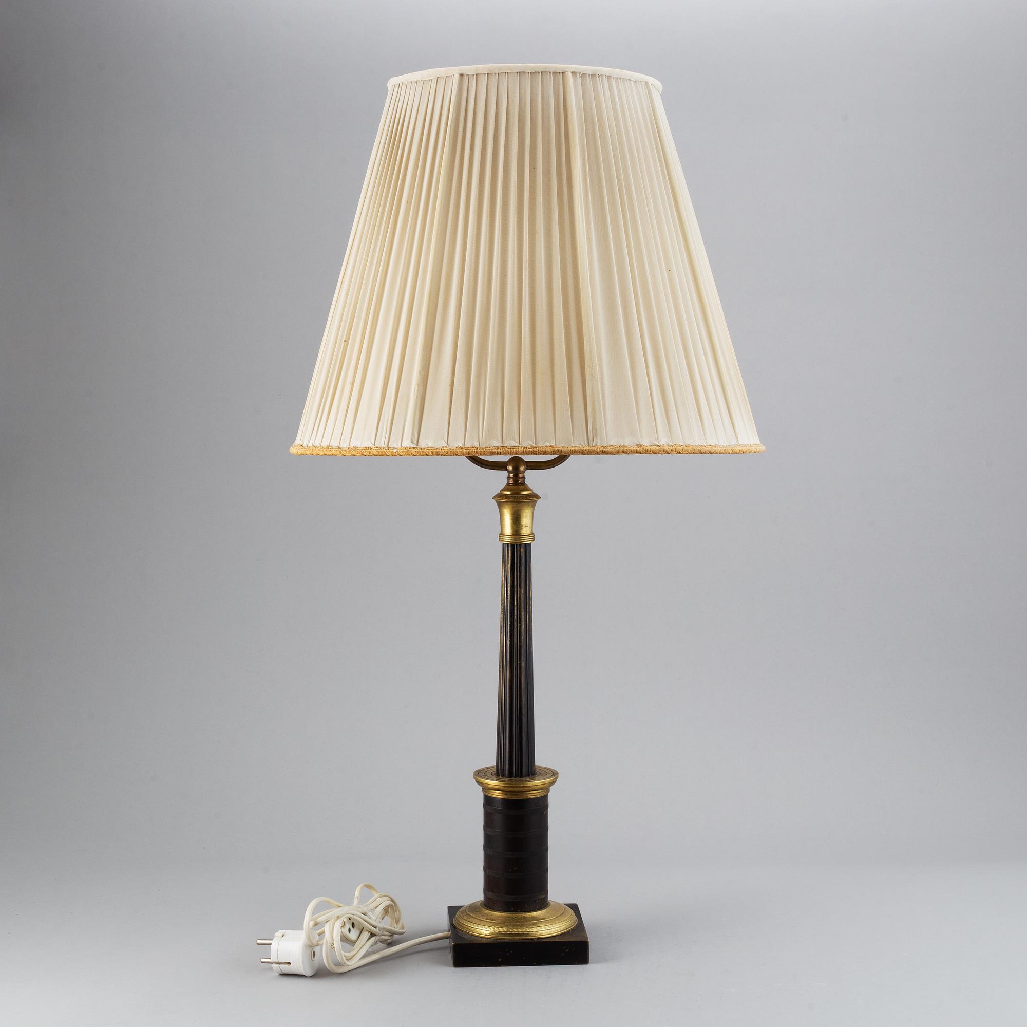 An empire style table lamp from the first half of the 20th century.