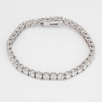 A line bracelet with 37 brilliant cut diamonds. Total carat weight 12.00cts.