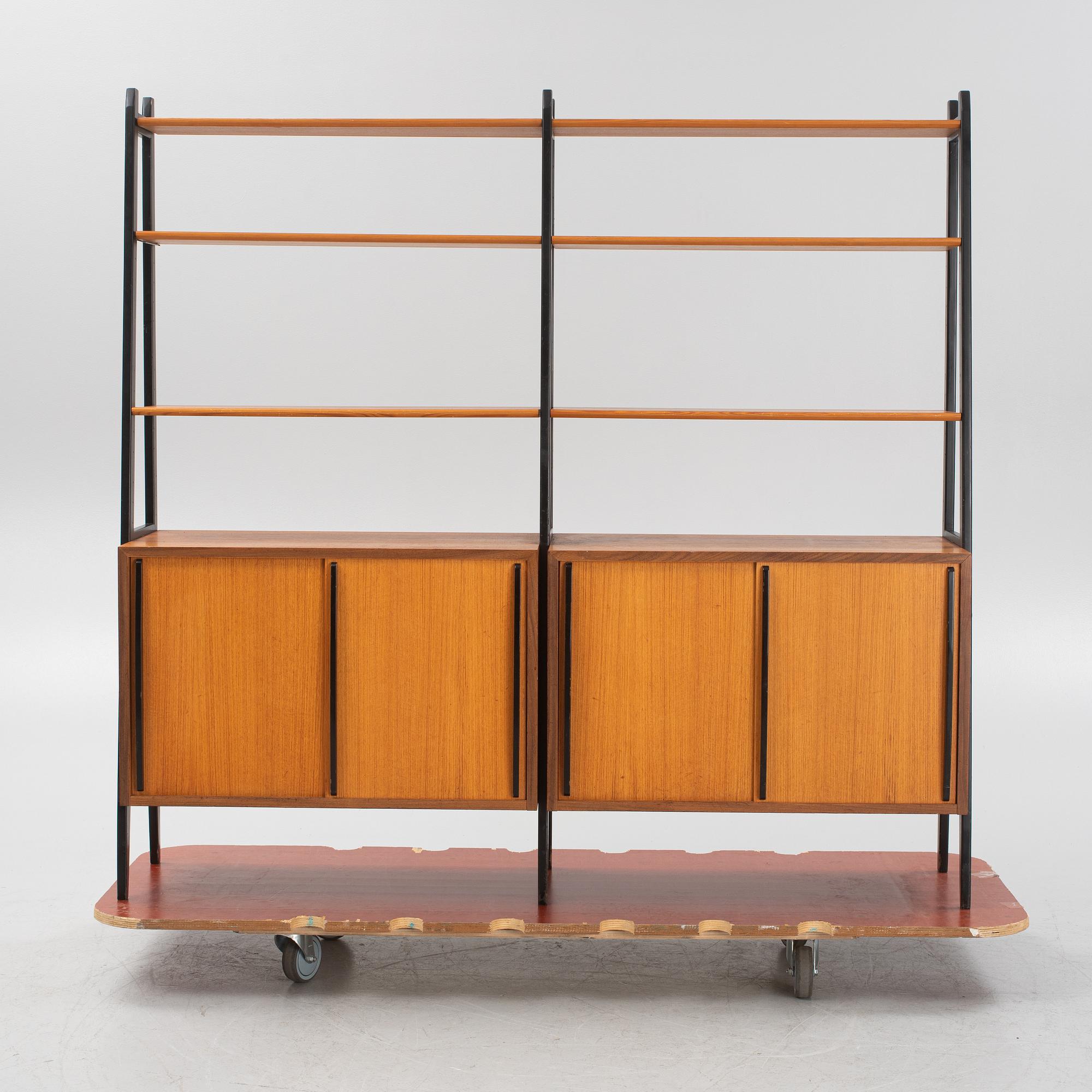 Teak veneered book cases with cabinets.