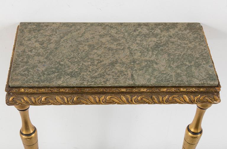 a bronzed mirror and a console table from the second half of the 20th century.