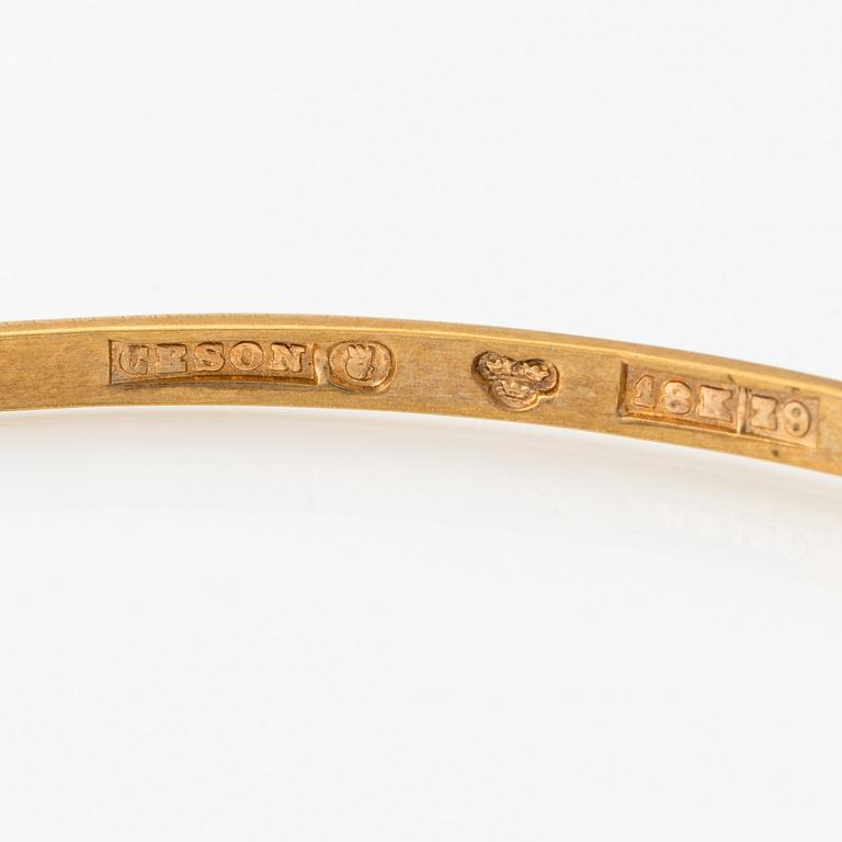 An 18K gold bangle.