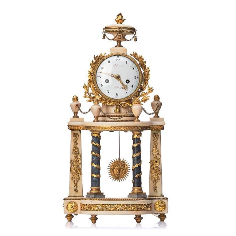 A Louis XVI gilt bronze and white and grey marble mantel clock.