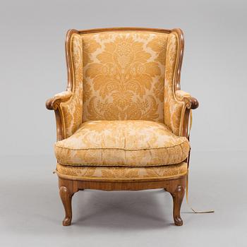 A Rococo style wing chair, first half of teh 20th Century.