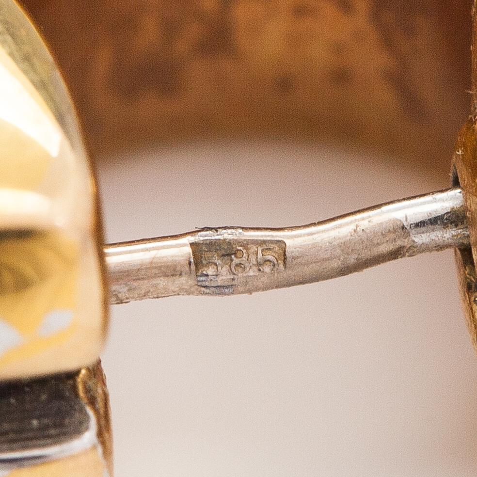 A pair of 14K gold earrings.