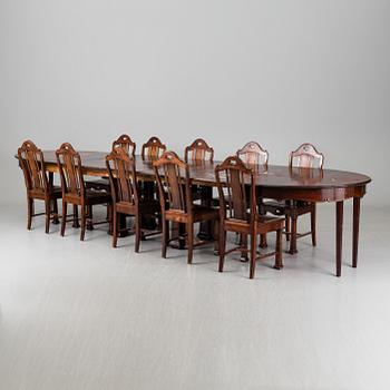 A late 19th century dining table with ten chairs and five extension leaves.