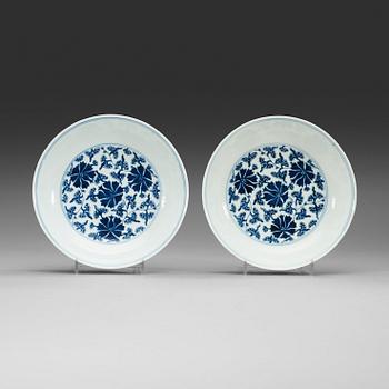 17. A pair of blue and white lotus dishes, Qing dynasty (1644-1912) with Qianlong seal mark.