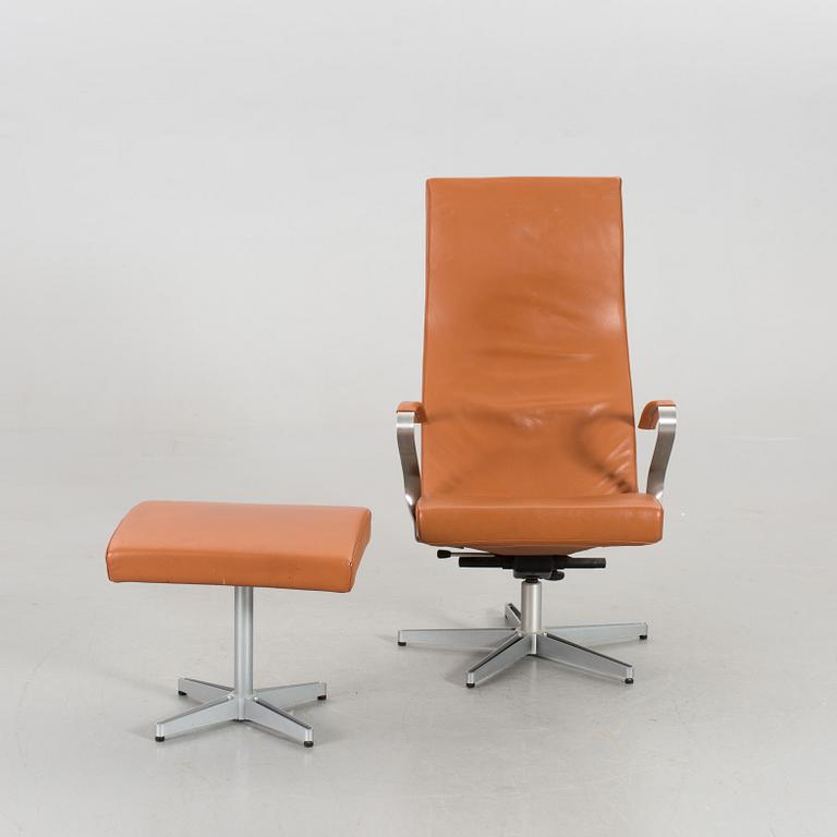 AN ARMCHAIR WITH STOOL MODEL "TWIST" DESIGNED BY JERKER ANDERSSON FOR SÖDERBERGS MÖBLER.
