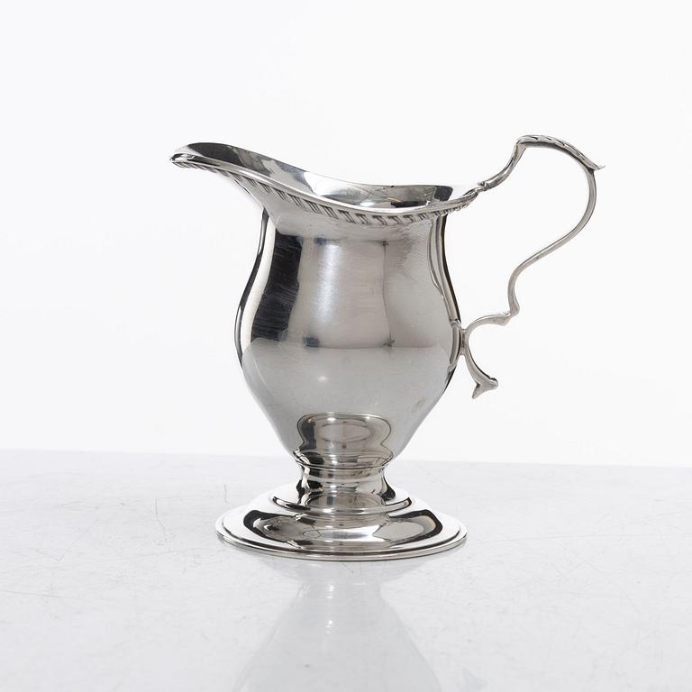 A silver cream jug, mark of S W Smith & Co, Birmingham, England 1929.