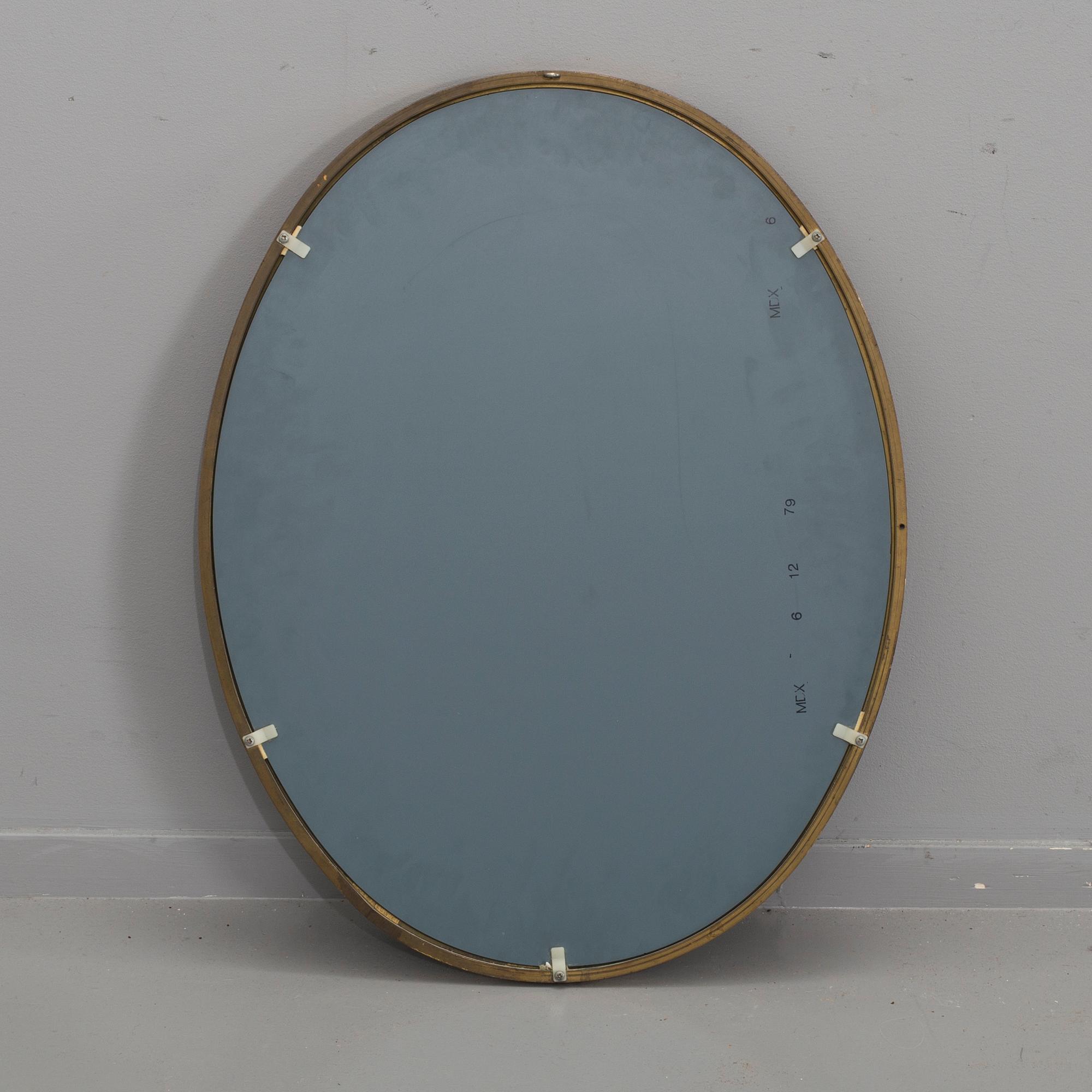 A 20th century brass mirror.
