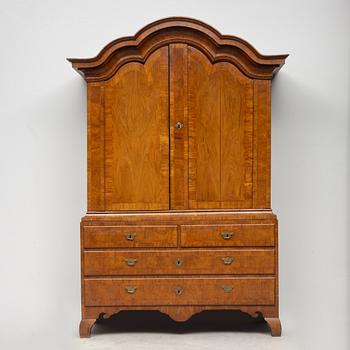 A late Baroque walnut-veneered cabinet in the manner of J. H. Fürloh, mid 18th century.