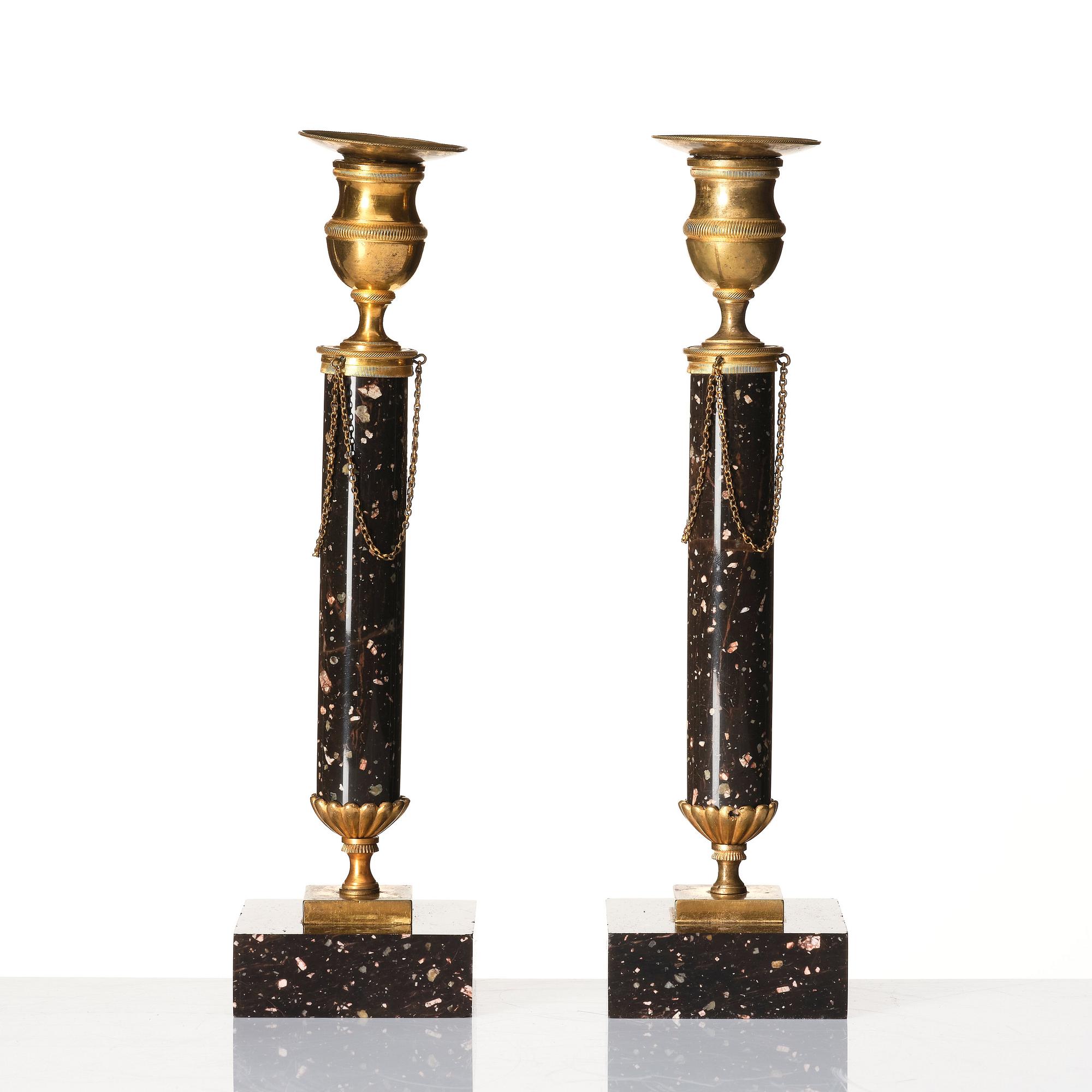 A pair of late Gustavian porphyry and gilt brass candlesticks, circa 1800.