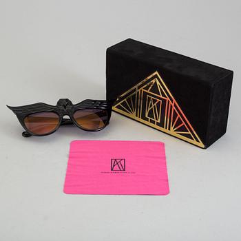 A pair of Anna-Karin Karlsson sunglasses.