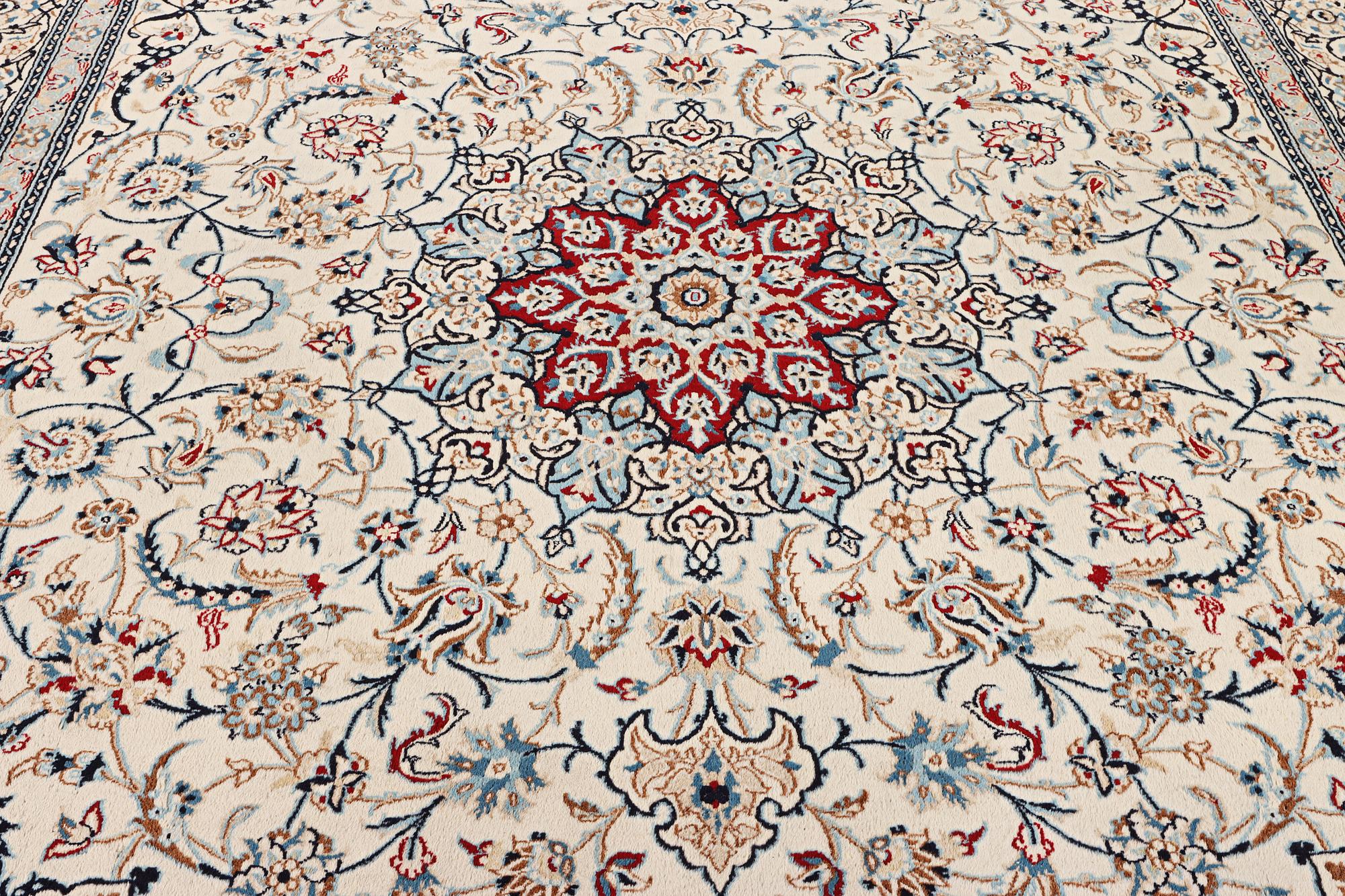 A Nain carpet, part silk, 9 laa, c. 390 x 295 cm.