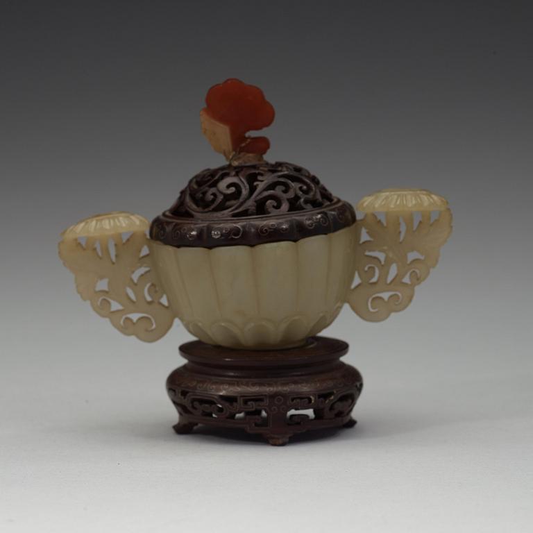 A nephrite cup with wooden cover and stand with silver inlay and quartz finial, Qing dynasty, 19th Century.