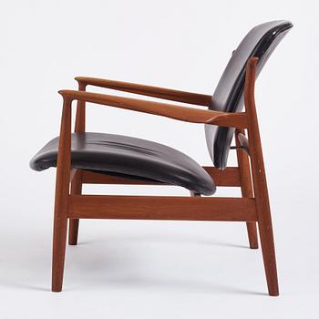 Finn Juhl, a teak and black leather 'model 136' easy chair, France & Daverkosen, Denmark 1950-60s.