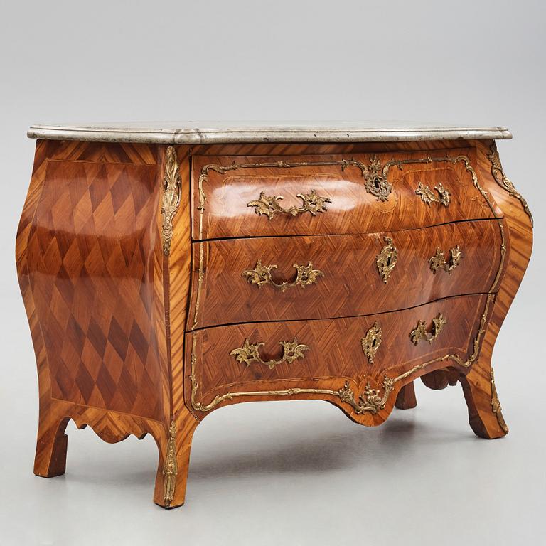 A rococo rosewood-veneered and ormolu-mounted commode by N. Korp (master 1763-1800).