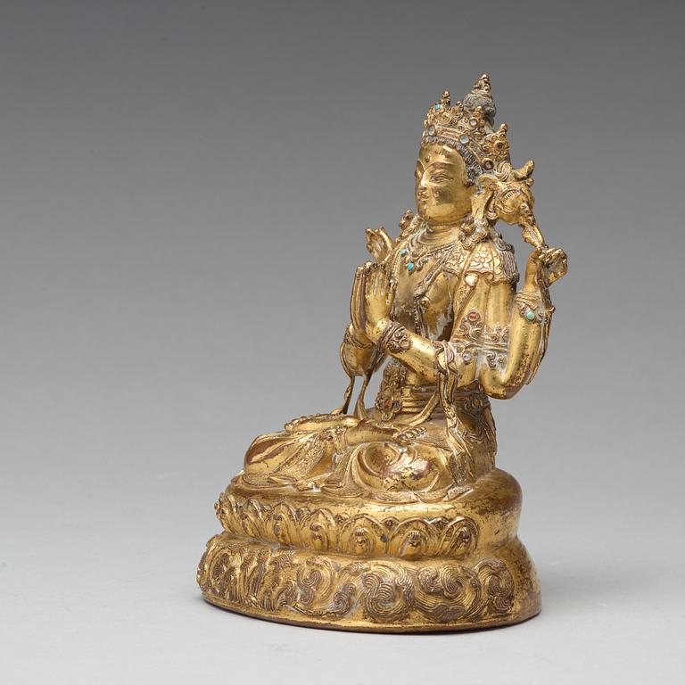 A gilt copper alloy four armed Sadaksari Avalokiteshvara, Tibet/Nepal, 15th Century or older.