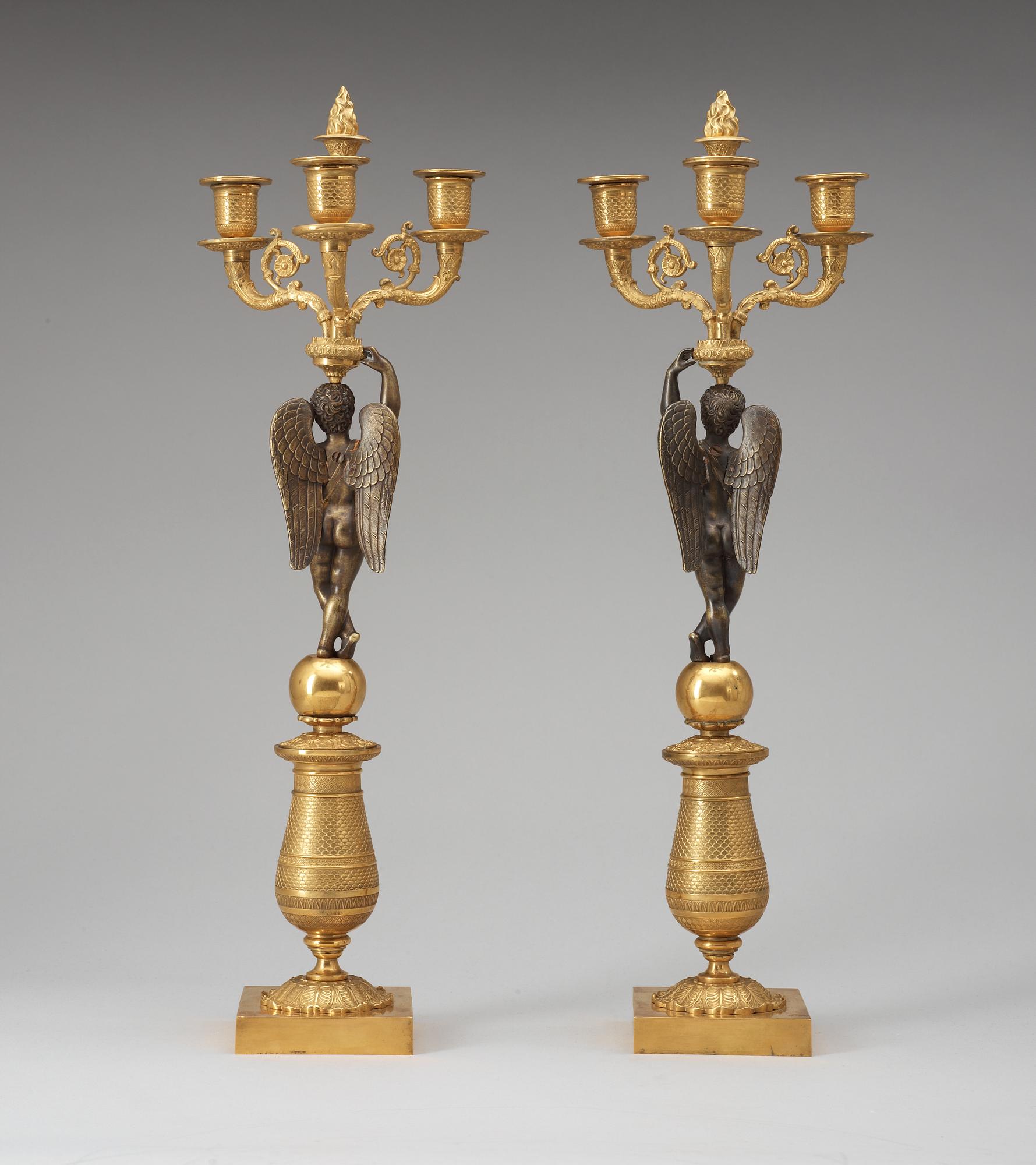 A pair of French Empire early 19th century three-light candelabra.