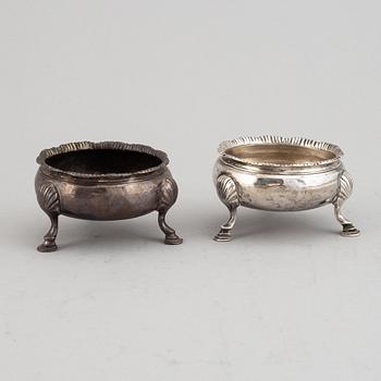 Two pairs of English 18th century silver salt-cellars, marked in London 1762 and 1769.