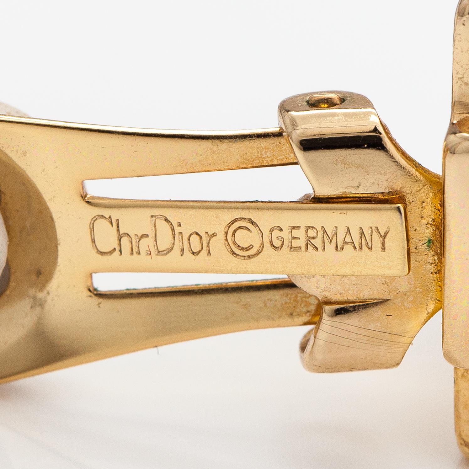 Christian Dior A pair of gold coloured metal earrings with rhinestones. Marked Chr. Dior Germany. Bukowskis
