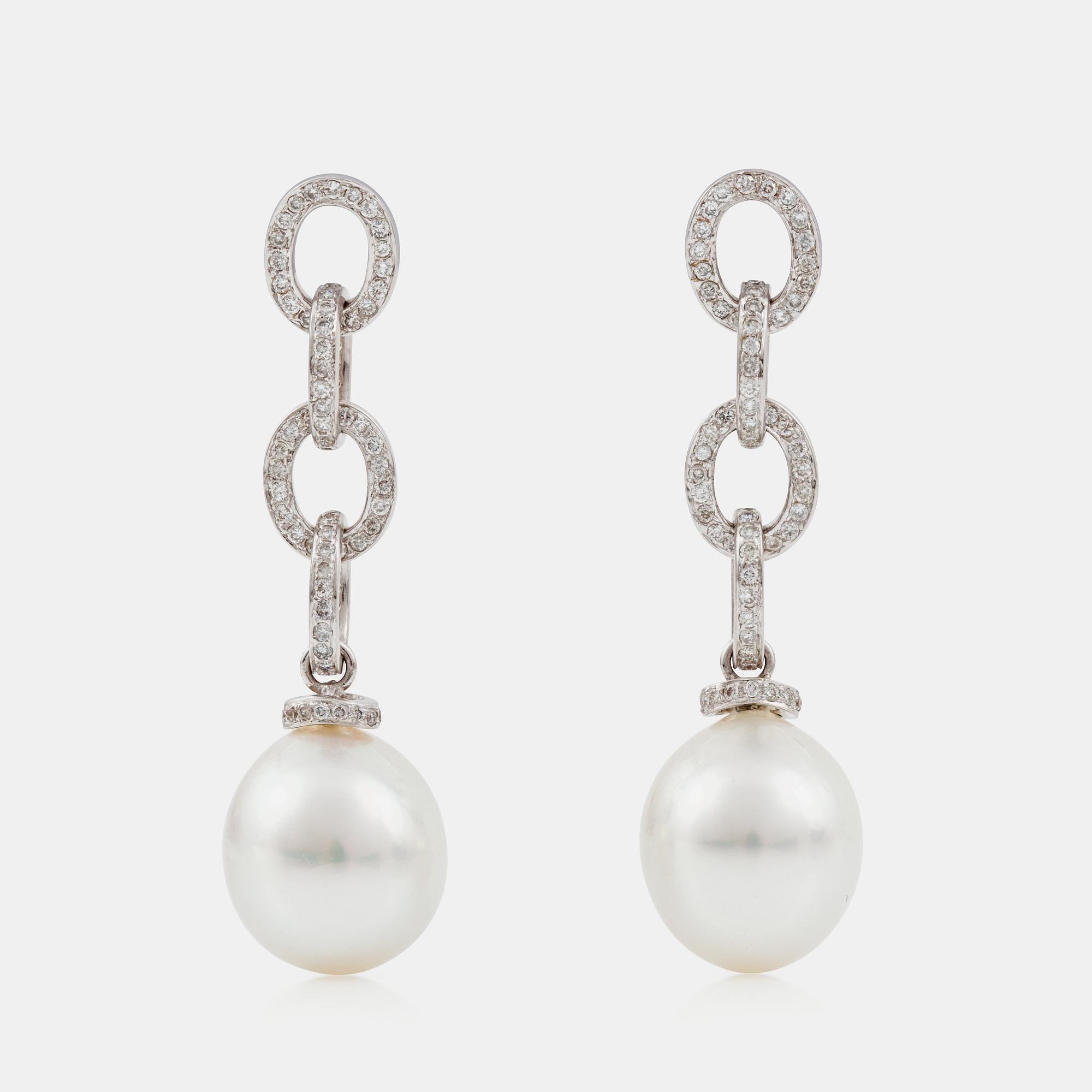 A pair of oval cultured South sea pearl and brilliant-cut diamond earrings. Pearls 12.5 - 15 mm.
