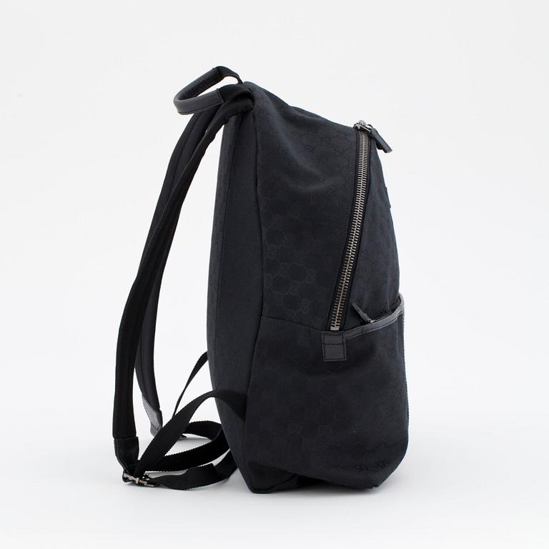 GUCCI, a black monogramed canvas backpack.