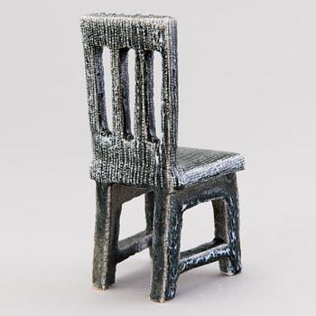HEINI RIITAHUHTA, a porcelain miniature sculpture 'Chair' signed Heini Riitahuhta.