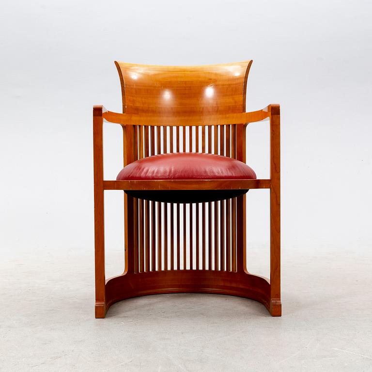 A cherry wood model 606 'Barrel' chair by Frank Lloyd Wright from Cassina.